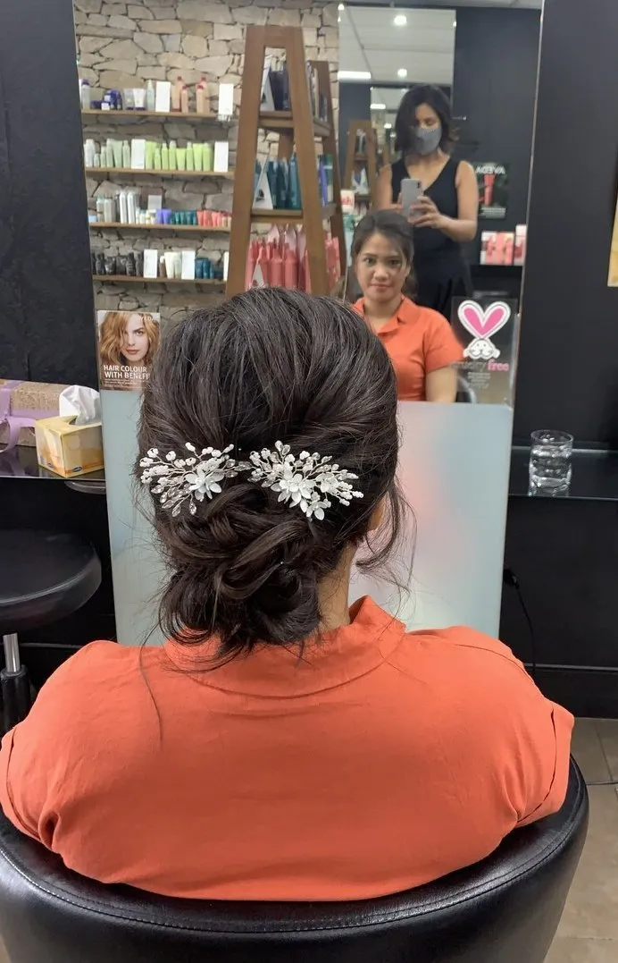 Elegant bridal upstyle with floral accessories at DC Hair Lounge
