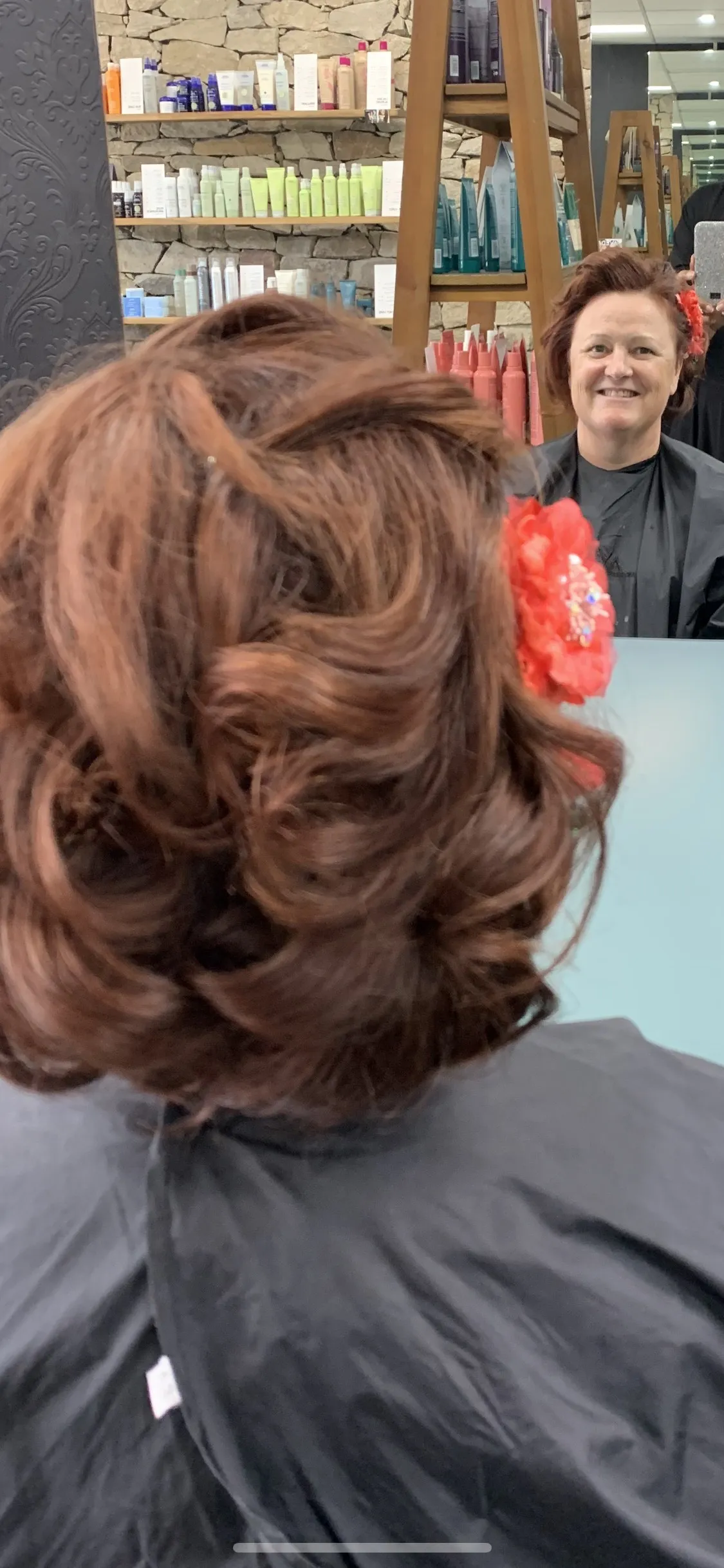 Auburn curly updo with red flower at DC Hair Lounge Baulkham Hills